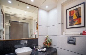 Een douche, een haardroger, pantoffels, handdoeken