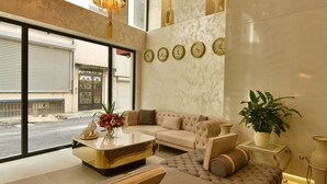 A modern living room with a sofa, coffee table, and decorative items. - G-Han Hotel (Istanbul)