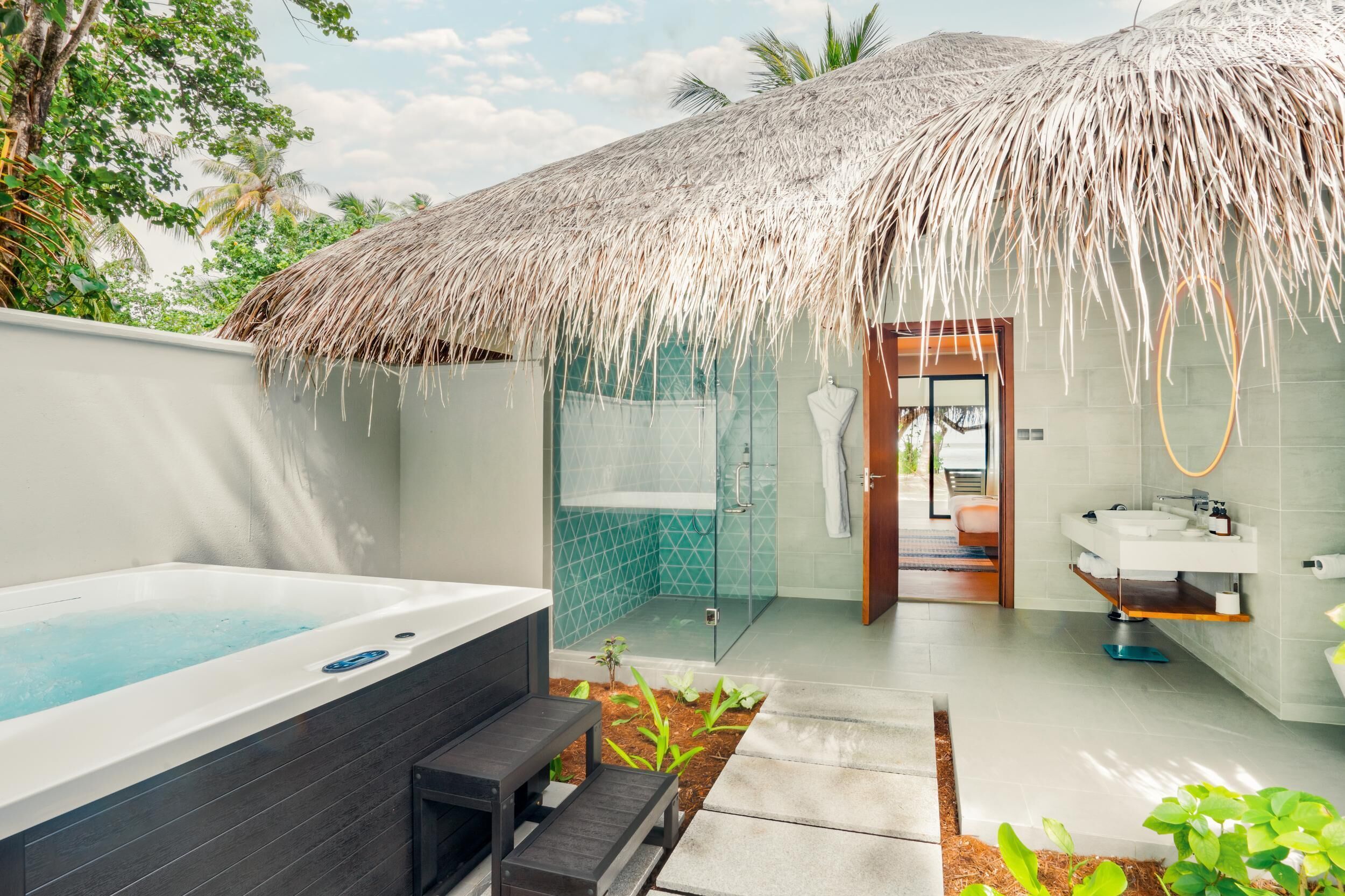 A modern bathroom with a glass shower, a bathtub, and a sink.