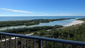 A coastal landscape with a clear sky, a beach, and a mangrove area. - Beachfront 2BR/2BA condo in Marco Island with pool, WiFi, and coastal views. (Marco Island)