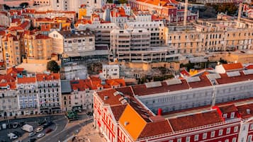 A cityscape with a prominent white dome building, red and white buildings, and a mix of residential and commercial structures.