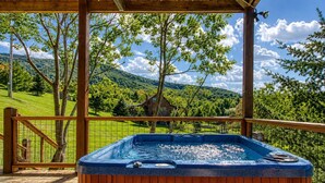 A hot tub in a wooden deck with a view of a house and hills. - Picture Perfect , Panoramic Mountain Views, $560 FREE tickets each paid day! (Sevierville)