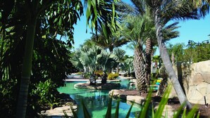 A serene pool area surrounded by lush greenery and palm trees. - Worldmark Reunion (Kissimmee)