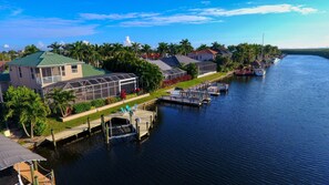 Enjoy waterfront views and serene surroundings from this tranquil property, featuring a dock and lush gardens.