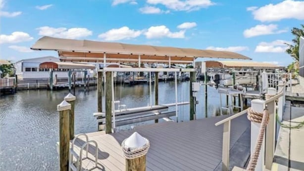 A marina with docked boats, a covered area, and a wooden deck. - Saint James hidden gem. 3/2 canal front home with 3 kayaks.  (Saint James City)