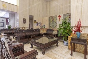 A spacious lobby with a large seating area, a reception desk, and a large plant. - Ruixue International Hotel (Gao'an)
