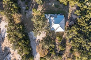 An aerial view of a house surrounded by trees.