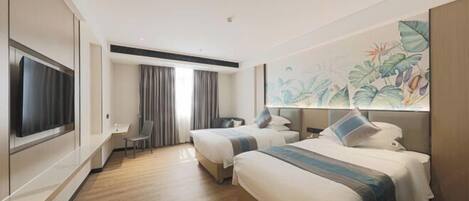 A hotel room with two beds, a flat-screen TV, a desk, and a large window.