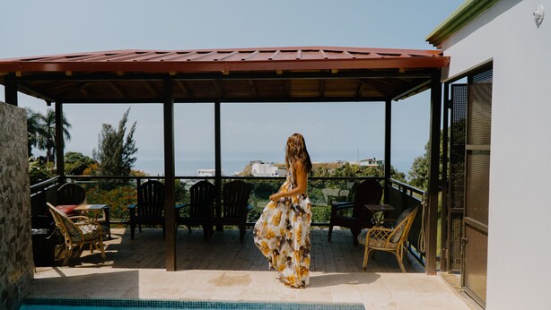 A covered outdoor area with a pool, chairs, and a view of the ocean. - VelBELA Rincon (Rincon)