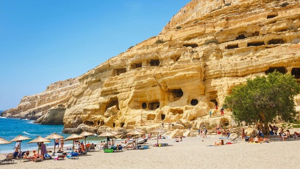 A beach with a rocky cliff featuring multiple caves and a clear blue sky. - Tranquil sea view villa with pool,2km from beach! (Agia Galini)