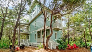 A two-story house with a porch and a staircase leading to the upper level. - 0.2 miles from the beach In the heart of Seagrove (Santa Rosa Beach)