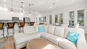 A modern kitchen with white cabinets, stainless steel appliances, and pendant lighting. - 0.2 miles from the beach In the heart of Seagrove (Santa Rosa Beach)