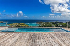 A wooden deck with a pool overlooking a coastal landscape with hills and the ocean. - Villa La Vue (1 bedroom) (Saint Barthélemy)
