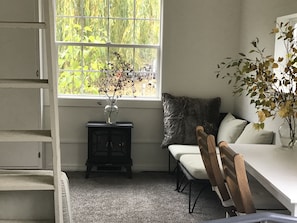 The electric fireplace, desk/table and sofa.  Kitchen is out of view on the left