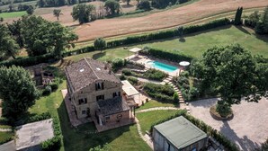 A large, rustic stone house with a swimming pool, surrounded by well-maintained gardens and a hilly landscape. - Villa Casanostra 12, Emma Villas (San Ginesio)