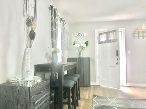 view from couch of the bar table and front door