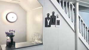 A staircase with a white railing and a wall-mounted sign with the letters "YUM". - Brilliant Bungalow (Dayton)