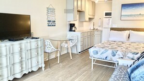 A compact hotel room with a bed, a desk with a TV, a kitchenette, and a dining area. - 2nd Floor Ocean View Condo•Pet Friendly•Pool•Private Beach Access (Atlantic Beach)