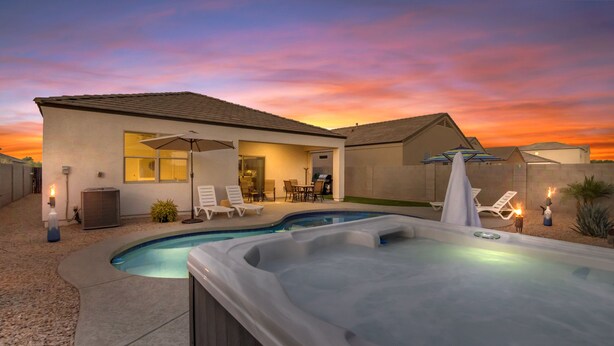 A backyard with a swimming pool, hot tub, and outdoor seating area. - East Valley Peaceful Oasis w/PRIVATE Pool that is HEATED at no extra cost (Florence)