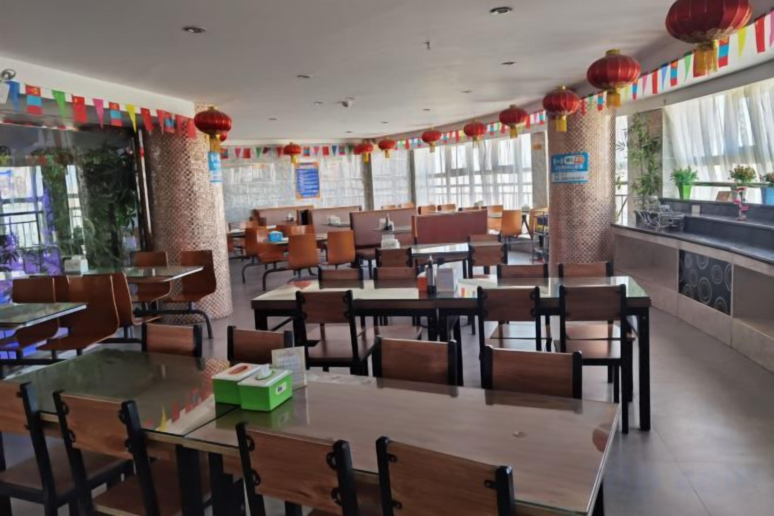 A restaurant with tables and chairs arranged for dining.
