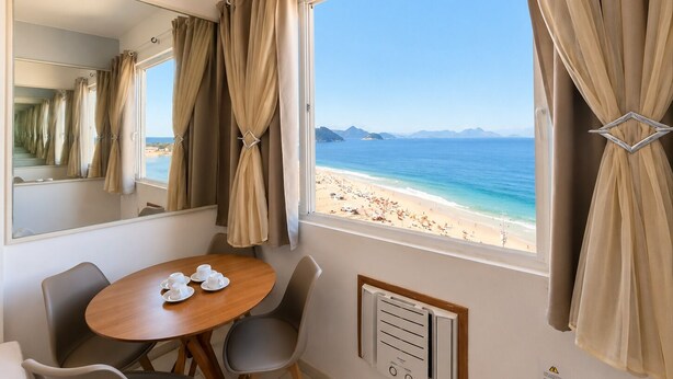 A room with a large window, a dining table with chairs, a mirror, and a wall-mounted air conditioning unit. - Ocean View Copacabana Best Spot (Rio de Janeiro)