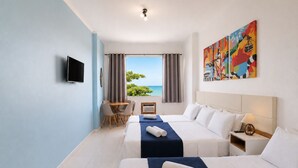 A hotel room with two beds, a TV, a dining area, and a painting. - Ocean View Copacabana Best Spot (Rio de Janeiro)