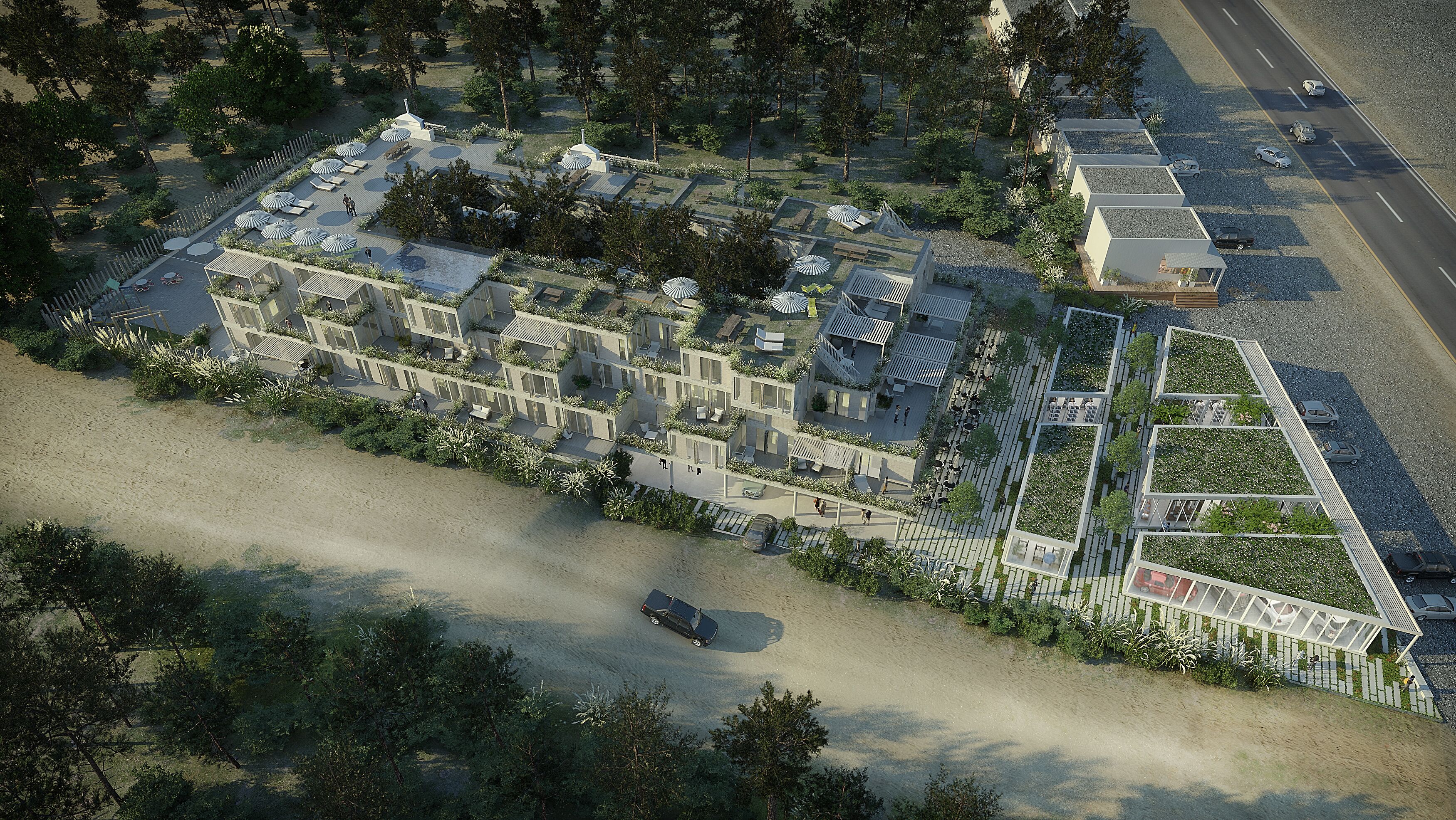 An aerial view of a modern residential complex with multiple buildings, a central courtyard with umbrellas, and a road with parked cars.