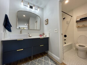 Bathtub, hair dryer, towels, soap