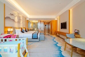 A hotel room with a bed, bedside table, chair, desk, and a large window. - Ruixiang Hotel (Fushun)