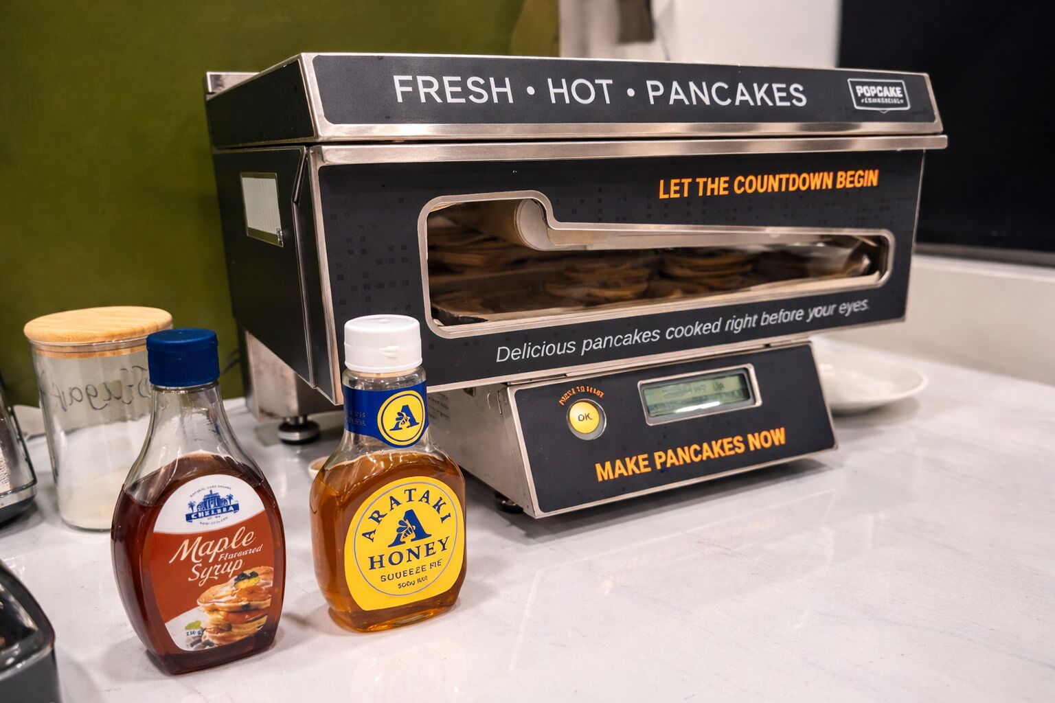 A pancake maker with the text 'FRESH HOT PANCAKES' and 'LET THE COUNTDOWN BEGIN' on it.