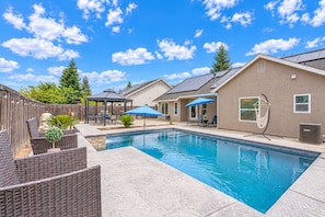 A backyard with a swimming pool, outdoor furniture, a gazebo, and a covered patio area. - Beautiful home W/Pool Close to National Parks. (Fresno)