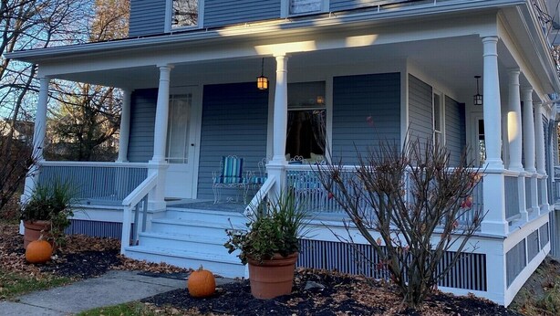 A two-story house with a porch, white columns, and a gabled roof. - Charming Victorian home (Groton)