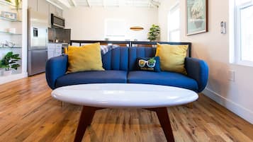 Open-concept studio with comfortable seating flowing into the kitchen