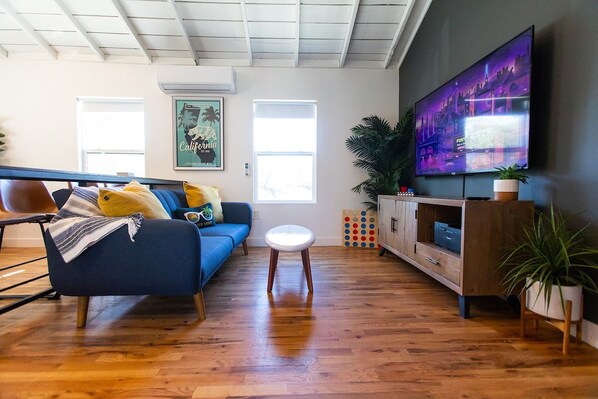 Bright, stylish studio living area with a cozy sofa bed