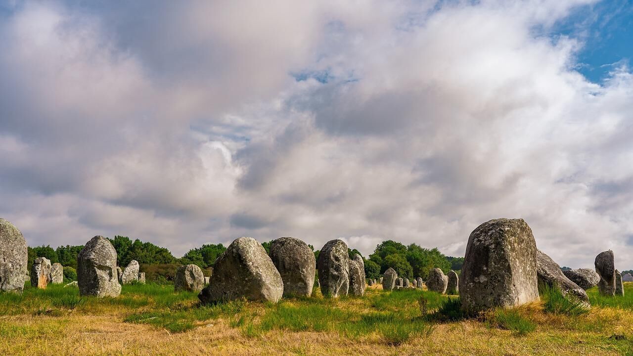 A field of standing stones under a cloudy sky.