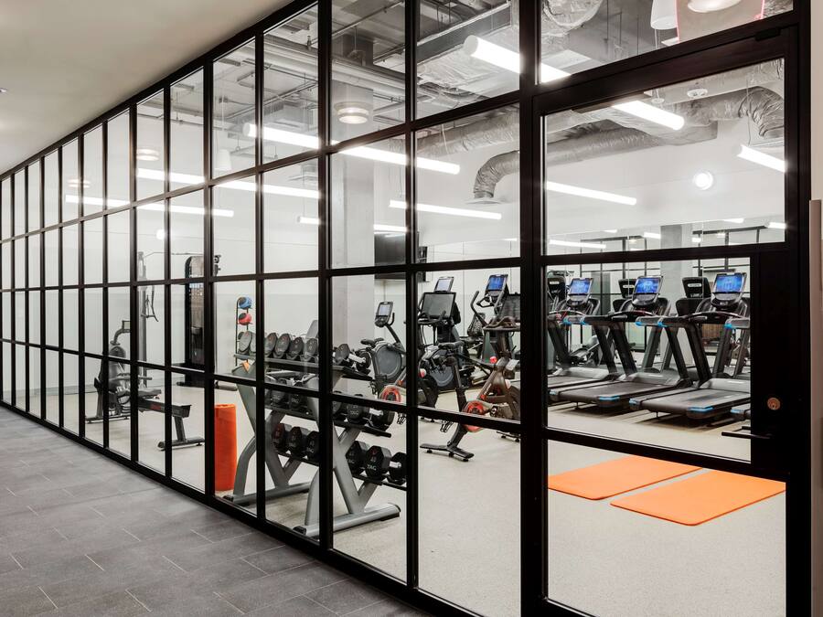 A gym with exercise equipment, treadmills, and weight machines.