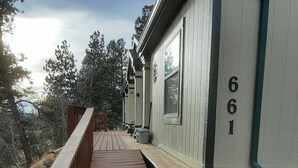 A wooden deck leading to a building with the number 661 on its side. - Forest cabin on 4 acres,  Newly renovated, Quiet and secluded. (Florissant)