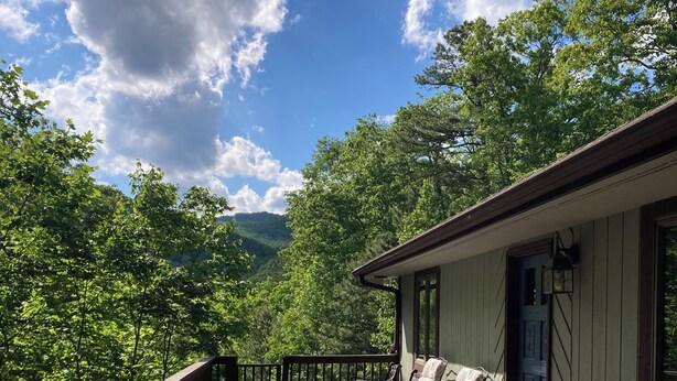 A wooden deck with outdoor furniture, a railing, and a building with a door and windows. - Private Family Mountain Getaway 6mi to Asheville (Fairview)