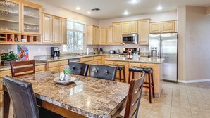 A modern kitchen with granite countertops, stainless steel appliances, and wooden cabinetry. - Golfer's Paradise: Oro Valley Home w/ Pool! (Oro Valley)