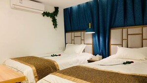 A hotel room with two beds, a desk, an air conditioner, and a blue curtain. - Impression Boutique Hotel (Shanghai Fengzhuang Metro Station Store) (Shanghai)