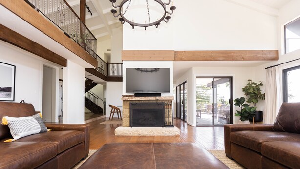 A spacious living room with a fireplace, leather sofas, and a large TV. - New! Breathtaking Patio Ocean Views, Private Riviera Retreat 30 Day Minimum (Santa Barbara)
