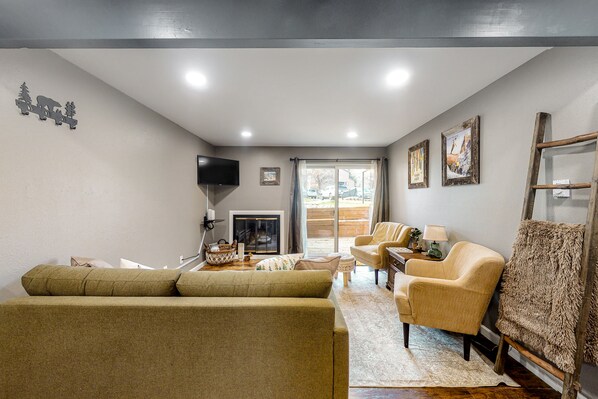 Relax in this inviting living room with a comfortable sofa, fireplace, and cozy seating area.
