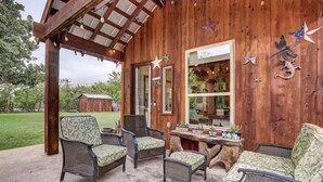 Una cabaña de madera con muebles de mimbre y adornos de estrellas.