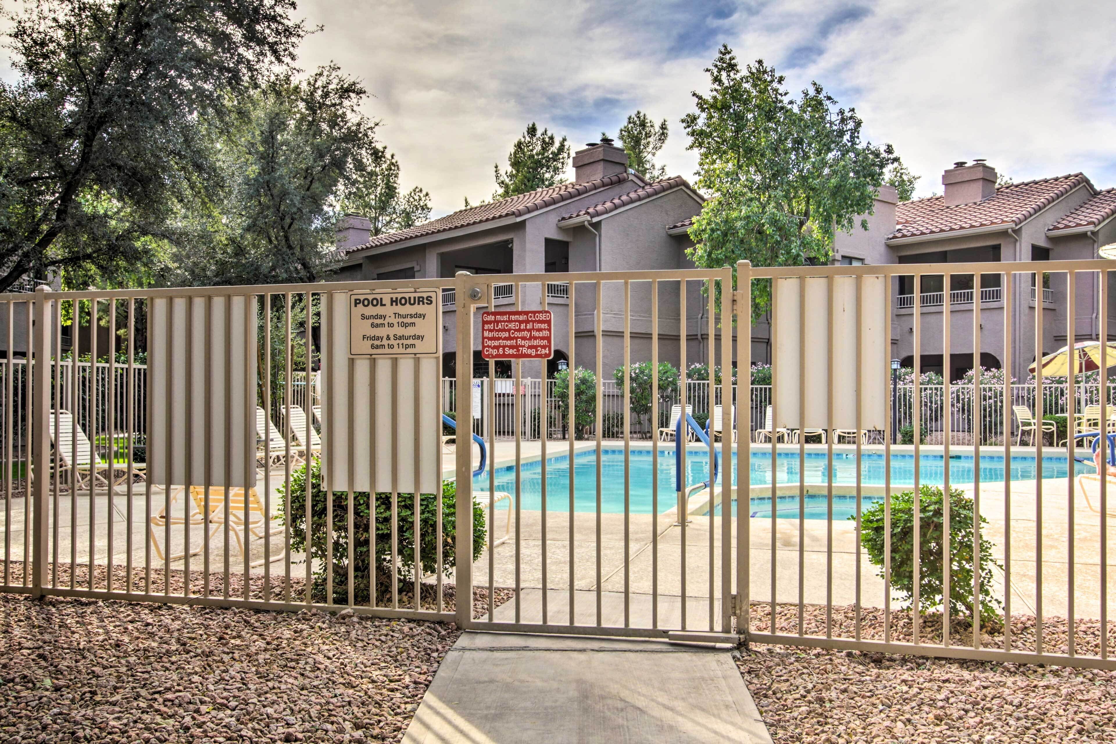 A gated pool area with a sign indicating pool hours and a closed gate due to health regulations.