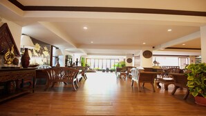 A spacious lobby with wooden flooring, multiple seating areas, and decorative wall art. - B2 Chang Phueak Gate Premier Hotel (Chiang Mai)