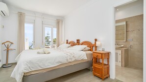 A bedroom with a bed, bedside table, and a view of the outside. - Apartment 'Wonderful Penthouse' with Garden, Terrace, Wi-Fi & A/C (Nerja)