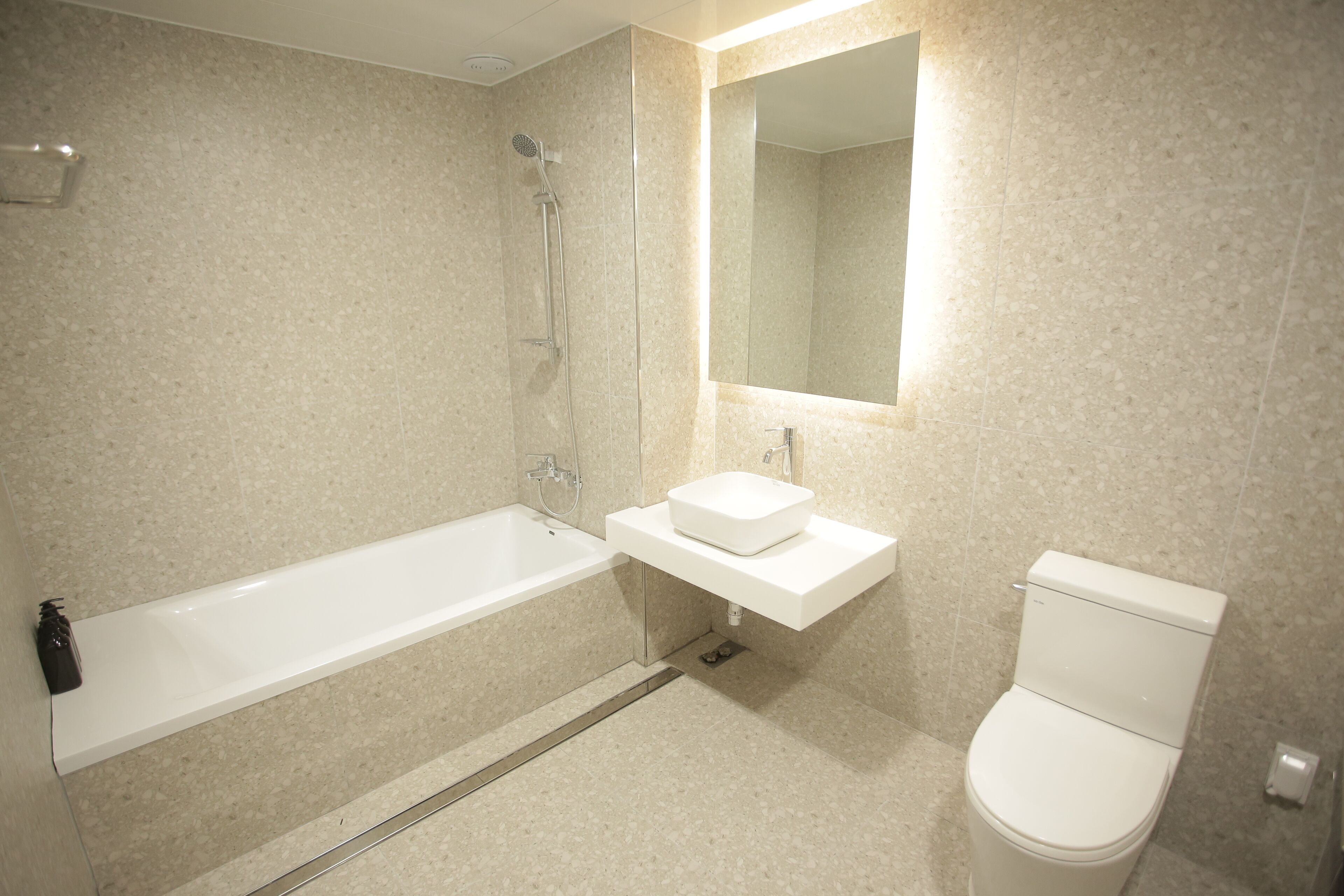 A bathroom with a bathtub, a sink, and a toilet.