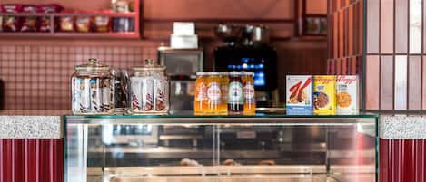 A bakery display with pastries and condiments.