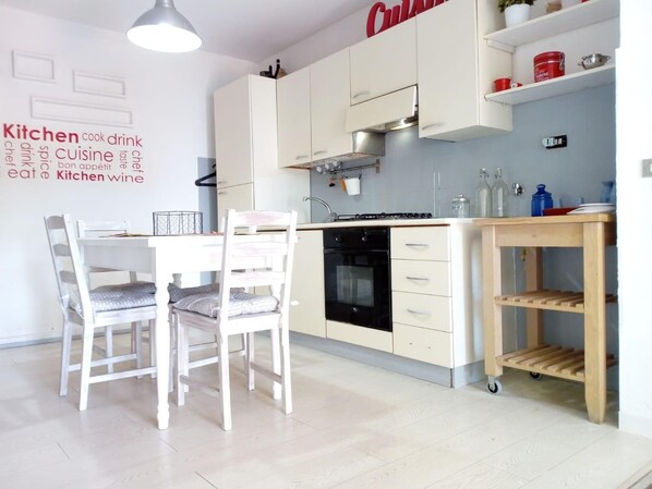 Modern kitchen with stove, sink, and ample counter space.