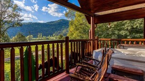 A wooden deck with a view of green hills and a clear sky. - Papa Bear, Hot Tub, WIFI,  $560 FREE tickets each paid day!!! (Sevierville)